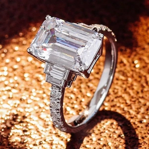 Elegant emerald-cut cubic zirconia ring with trapezoid side stones and pavé set diamonds
