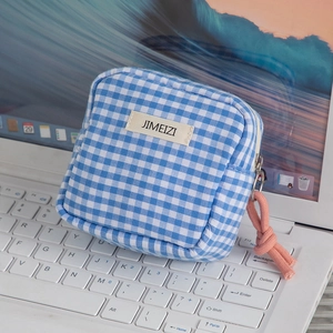 Close-up of blue and white checkered mini pouch with pink woven cord zipper pull