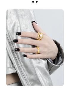 Close-up of double-layered gold rope rings with baroque pearl on a model hand
