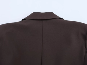 Close-up of the high-quality collar stitching on the dark brown double-breasted blazer