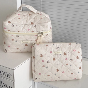 Detailed view of quilted cotton makeup bags set with cute bear and donut print patterns