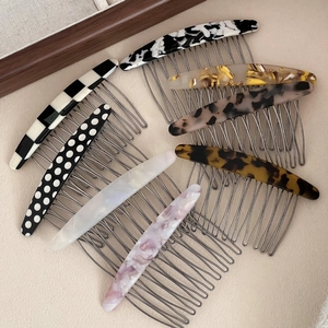 Various acetate hair side combs in tortoise and checkered patterns with metal teeth