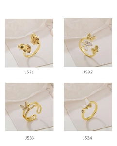 Detailed comparison of four gold butterfly open rings with cubic zirconia and shell inlays
