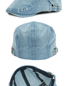 Detail view of washed denim flat cap with adjustable metal buckles and cotton fabric