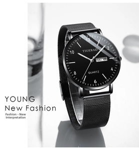 Detail of black quartz watch face with date window and mesh band by Tigerao