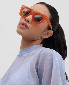 Fashionable orange square sunglasses for women worn by model for face framing detail