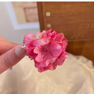 Close-up of pink gradient chiffon rose hair claw clip with delicate petal details