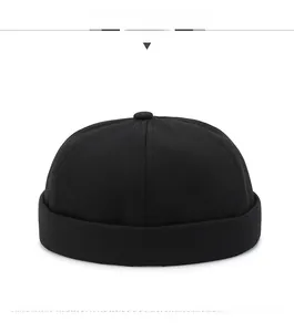 Detailed front view of black cotton twill brimless docker cap with stitched panels