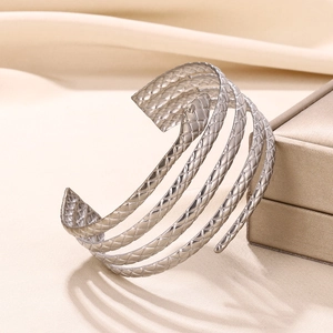 Detailed close-up of a silver snake-shaped multi-layer cuff with realistic scale textures