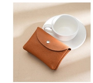 Close-up of brown lychee texture leather coin purse with silver metal snap button