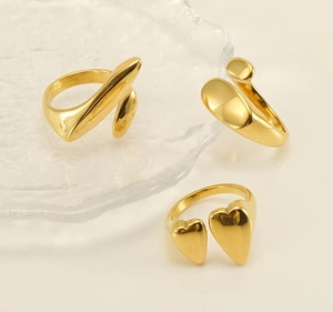 Detailed view of three 18k gold-plated stainless steel adjustable rings with geometric shapes