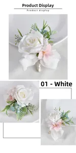 Detail of white rose boutonniere with silk ribbon handle and small pink floral accents