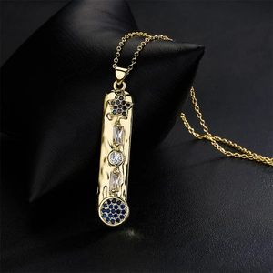 Gold-plated rectangle pendant necklace with blue and clear crystal gems on black leather