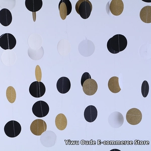 Close-up of black white and gold glitter paper circle garlands for party decor