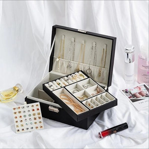 Black double-layer PU leather jewelry box organizer with locks on white silk background