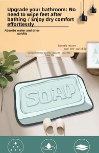 Detailed view of a mint green soap-shaped absorbent bath mat with 3D embossed lettering