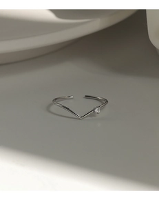 Detailed close-up of a minimalist S925 sterling silver V-shaped ring with a small diamond