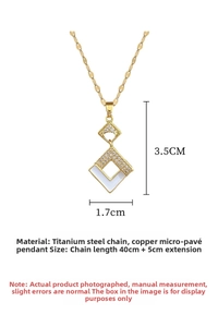 Detailed view of square gold necklace with micro-pave crystals and white enamel pendant