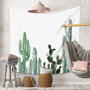 Detailed view of bohemian cactus tapestry hanging in a cozy minimalist living room setup