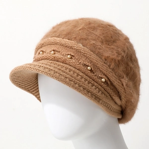 Detail of brown knit beanie showing fluffy rabbit fur texture and pearl embellishments