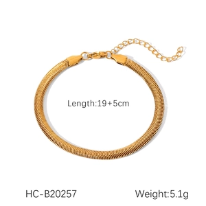 Detail of 18K gold snake bone bracelet with lobster clasp and adjustable extension chain