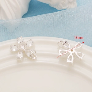 Detailed macro view of a 16mm flower pendant with clear zircon stones for DIY jewelry