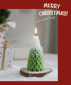 Detail view of two-tone Christmas tree candle with snow effect and wood base