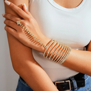 Detailed view of luxury gold multi-layer rhinestone hand chain and ring bracelet