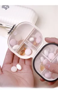 Detailed view of internal compartments and secure metal latch on the mini pill organizer