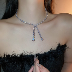 Close-up of teardrop zircon stones on silver adjustable Y-shaped choker necklace