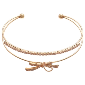 Elegant gold double-layer open bangle featuring a sparkling zircon-encrusted bow design