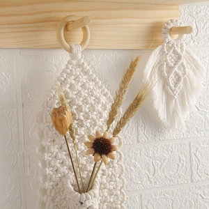 Bohemian macrame wall hanging with handwoven cotton rope tassels and wooden ring decor