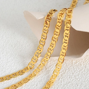 Polished 18k gold Cuban anchor chain necklace for men on minimalist stone background