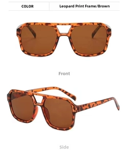 Close-up of double-bridge aviator sunglasses with leopard print frames and brown lenses