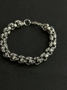Close-up of vintage silver skull link bracelet with intricate metal craftsmanship