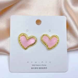 Detail of pink heart stud earrings with hammered gold borders on S925 silver needles