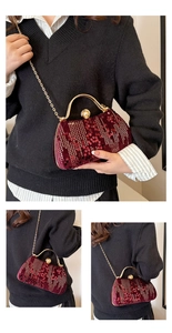 Detail of burgundy sequin evening bag with gold circular handle and metal chain strap