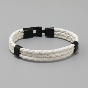 Detail showing white braided leather texture and black metal clasp on a punk style bracelet