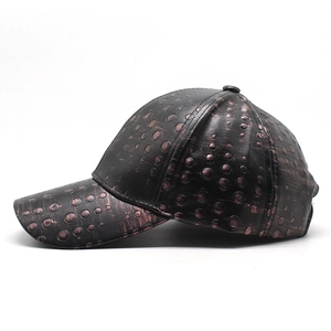 Close-up of vintage bronze PU leather baseball cap with embossed dot texture and neat stitching