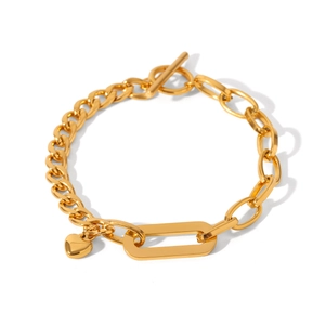 Detail of golden heart charm bracelet with OT toggle clasp and chunky cuban chain links
