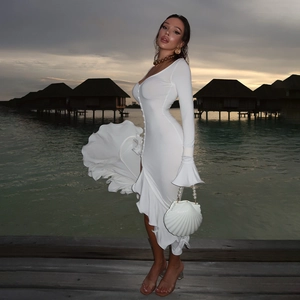 Elegant white slim fit long dress with bell sleeves and button detail by the coast