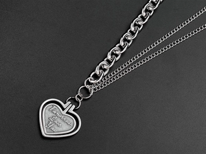 Detailed close-up of double layer heart pendant necklace with Tomorrow Love You engraving