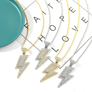 Macro view of gold and silver hip hop lightning bolt necklaces with inlaid zircon diamonds