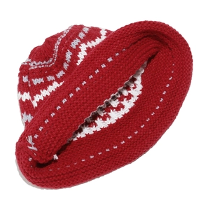 Detail of red and white Fair Isle knit pattern on winter hat with ear flaps