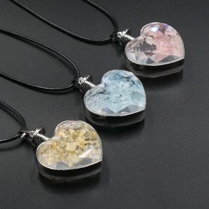 Three heart-shaped necklaces with colorful natural stone chips and black cords