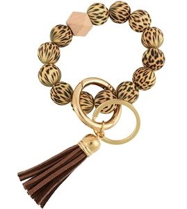 Detail of leopard print beads keychain bracelet with brown tassel and gold clasp