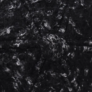 Close-up of black and grey tweed fabric texture with thick knit bouclé yarn fibers