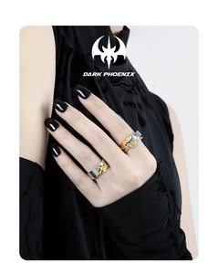Close-up of dual-tone silver and gold plated textured rings on a model hand