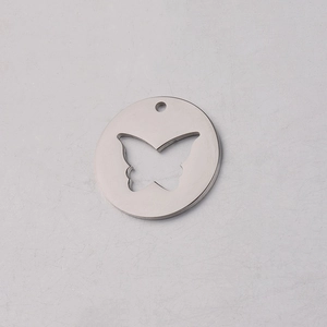 Detailed macro view of mirror-polished stainless steel round pendant with butterfly cutout