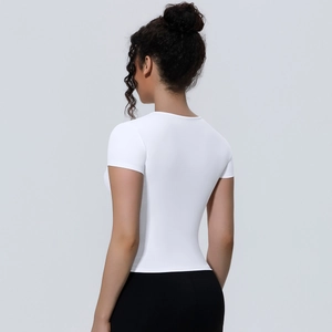 Close-up back view of a white slim-fit yoga T-shirt showing breathable fabric texture